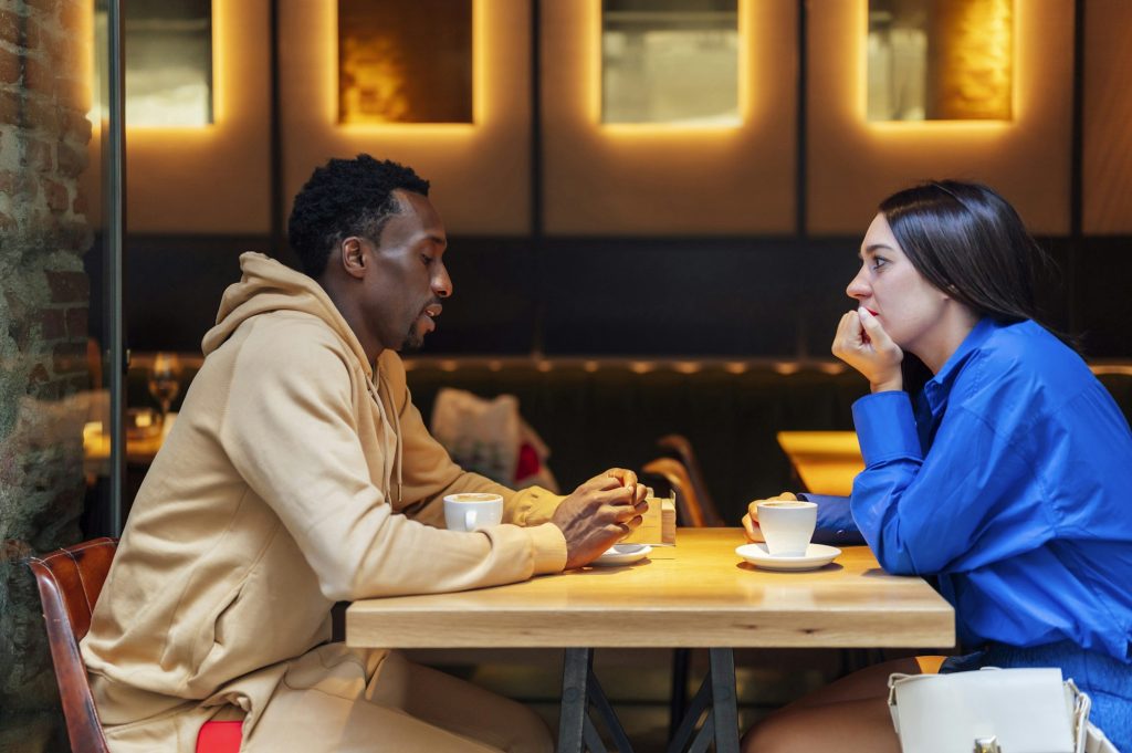 Couple talking serious in a cafe