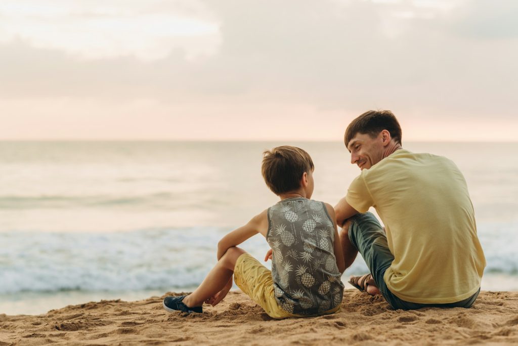 dad and son on the beach